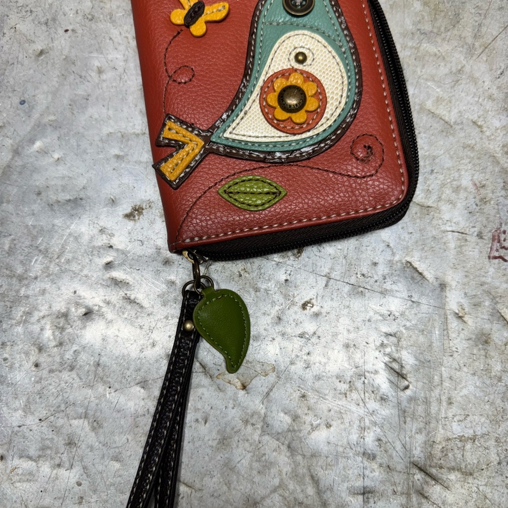 Chala wristlet wallet with bird design. Leaf zipper pull with wristlet strap